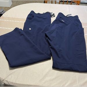 Two pairs of Figs Tech women’s scrubs pants. Size large.  Navy